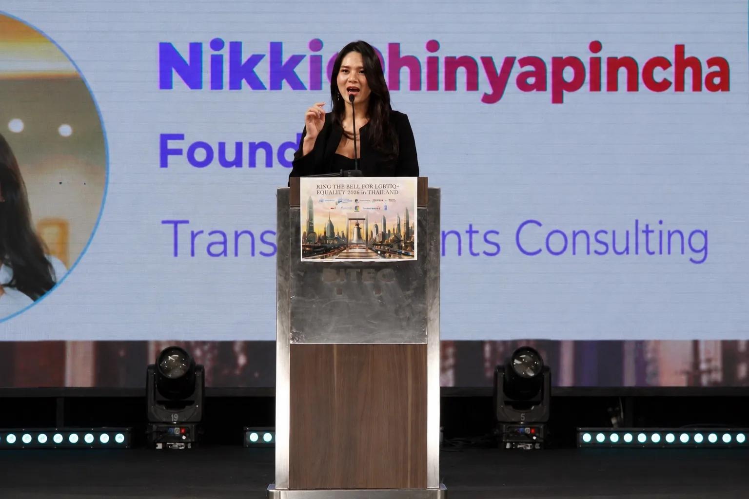 Nikki Phinyapincha, Founder of TransTalents Consulting Group, speaking at the podium during the Ring the Bell for LGBTIQ+ Equality ceremony at Pride Show 2026